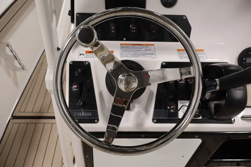 Slide: The Image of Steering wheel of 2026 Yamaha Boats 195 FSH Sport, showcasing control panel and throttle. - 35