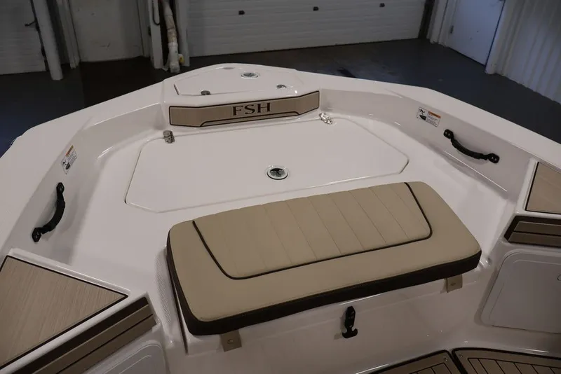 Slide: The Image of 2026 Yamaha Boats 195 FSH Sport interior with beige seating and storage compartments. - 8