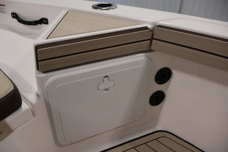 Slide: The Image of 2026 Yamaha Boats 195 FSH Sport interior detail with storage compartment and wood accents. - 16