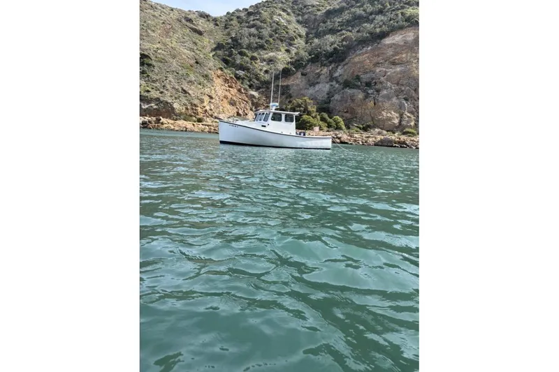 Slide: The Image of 1999 Samson East Coast Lobster boat docked at marina under cloudy sky. - 1