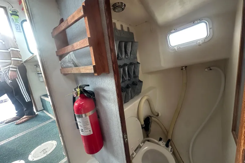 Slide: The Image of Interior of 1999 Samson East Coast Lobster boat with toilet and fire extinguisher. - 10