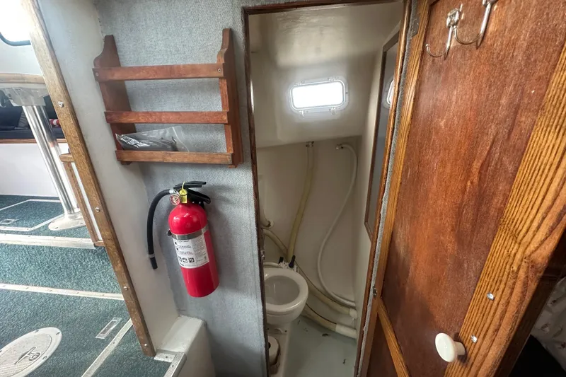 Slide: The Image of 1999 Samson East Coast Lobster boat interior with fire extinguisher and compact bathroom. - 11