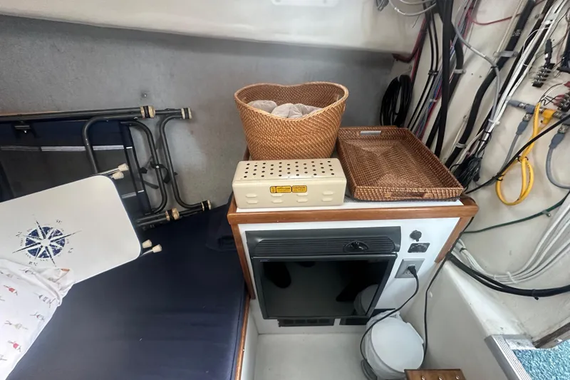 Slide: The Image of Interior of 1999 Samson East Coast Lobster boat with storage baskets and electrical wiring. - 12