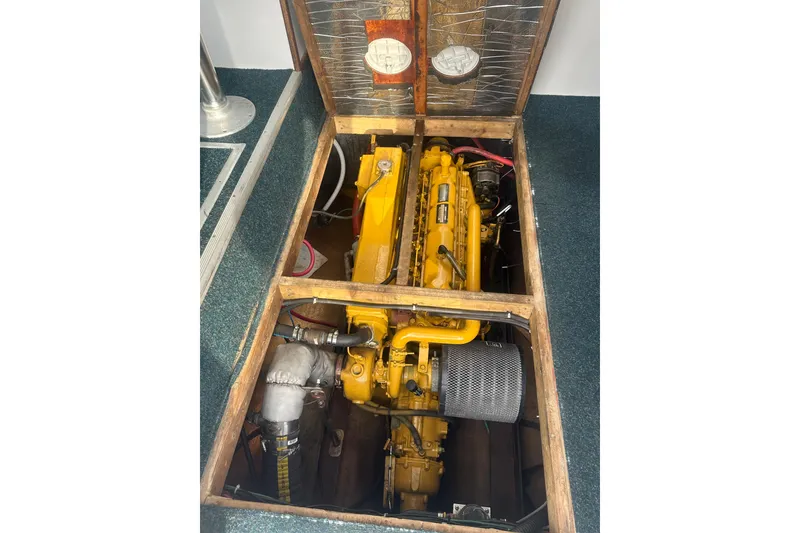 Slide: The Image of Yellow engine inside a 1999 Samson East Coast Lobster boat, viewed through an open hatch. - 18