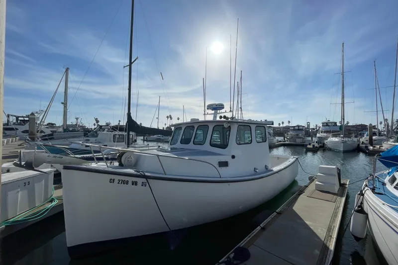 Slide: The Image of 1999 Samson East Coast Lobster boat docked in a sunny marina. - 20