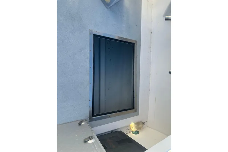 Slide: The Image of Interior view of a 1999 Samson East Coast Lobster boat with a window and light fixture. - 21