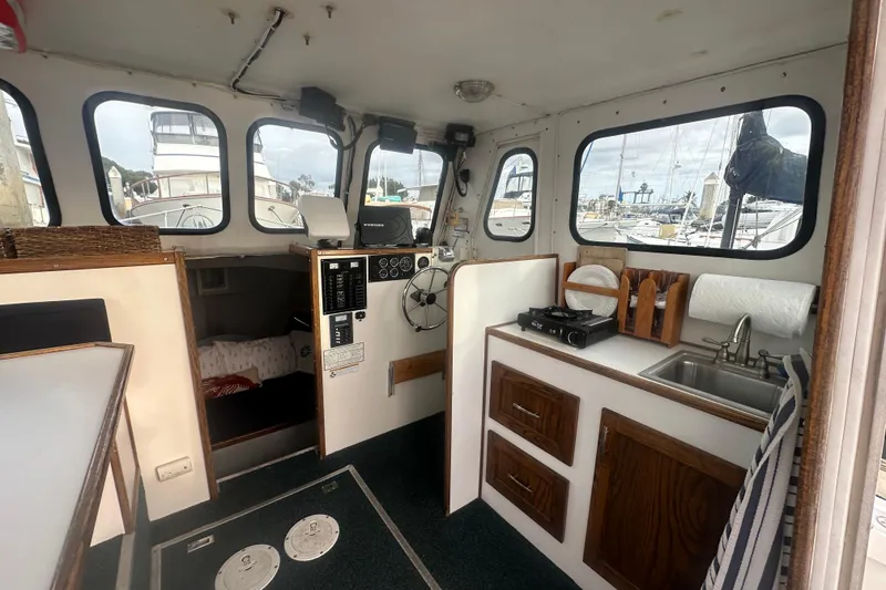 Slide: The Image of Interior of 1999 Samson East Coast Lobster boat with kitchenette and helm, docked at marina. - 4