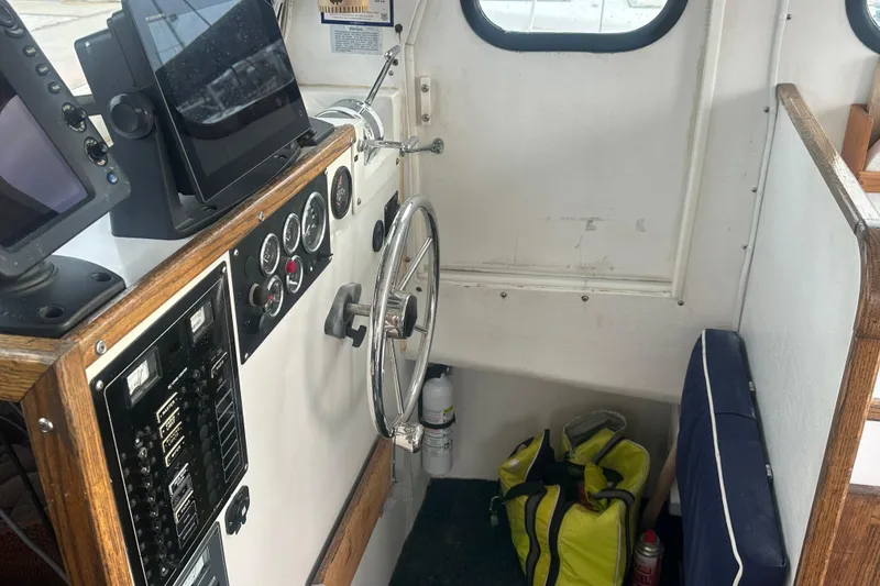 Slide: The Image of Interior of 1999 Samson East Coast Lobster boat with steering wheel and navigation equipment. - 6