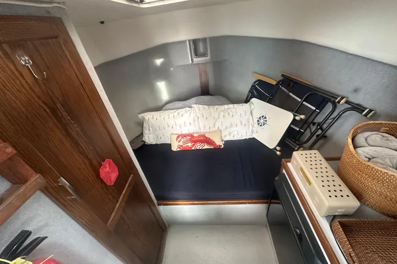 Slide: The Image of Cozy cabin interior of a 1999 Samson East Coast Lobster boat with bedding and storage. - 9