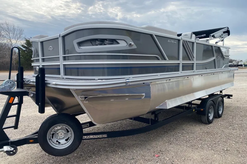 Slide: The Image of 2026 SunCatcher Diamond Elite 324 SS pontoon boat on trailer, parked outdoors. - 3