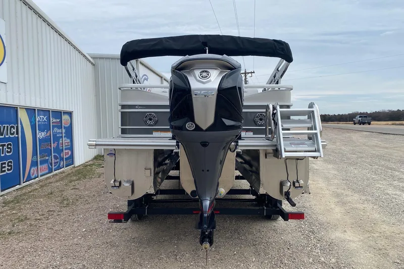 Slide: The Image of 2026 SunCatcher Diamond Elite 324 SS pontoon boat with outboard motor, parked outdoors. - 5