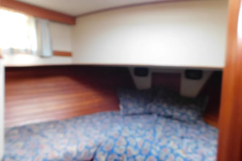 Slide: The Image of Cozy cabin interior of 1986 Grand Banks 46 Classic yacht with patterned bedding. - 16