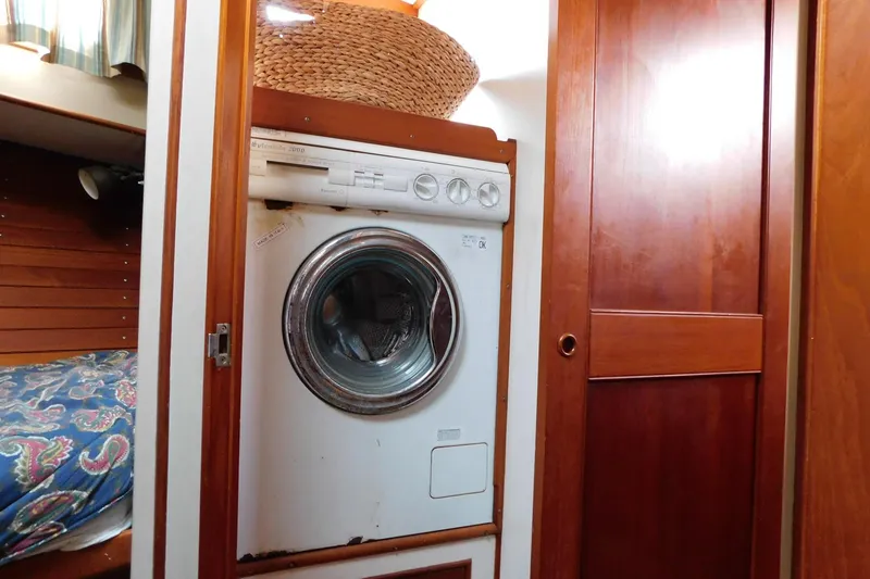 Slide: The Image of Laundry area inside 1986 Grand Banks 46 Classic yacht with wooden cabinetry. - 17