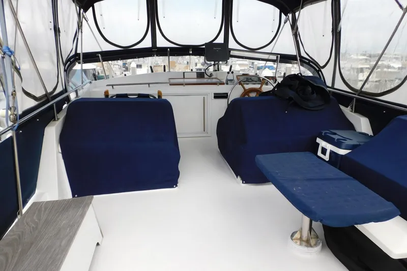 Slide: The Image of Interior view of 1986 Grand Banks 46 Classic yacht with blue seating and helm. - 20