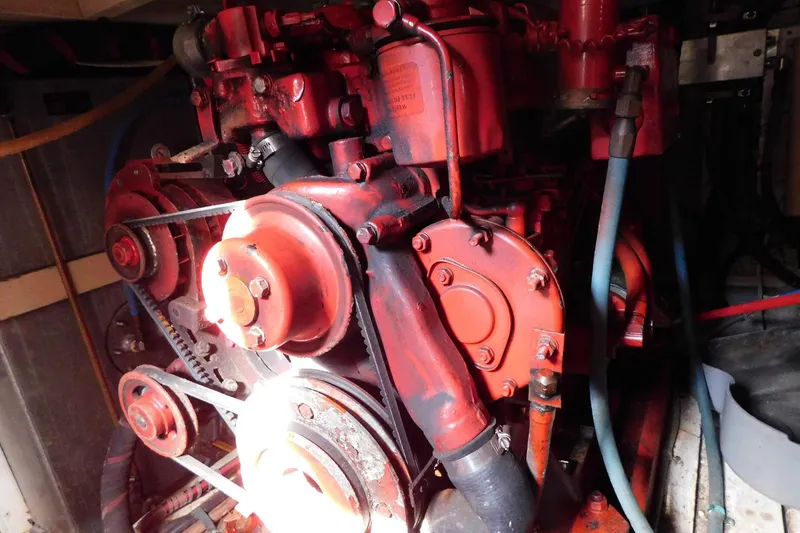 Slide: The Image of Engine of 1986 Grand Banks 46 Classic boat, showcasing mechanical components and belts. - 26