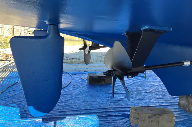 Slide: The Image of 1986 Grand Banks 46 Classic boat propeller and rudder, freshly painted blue. - 28