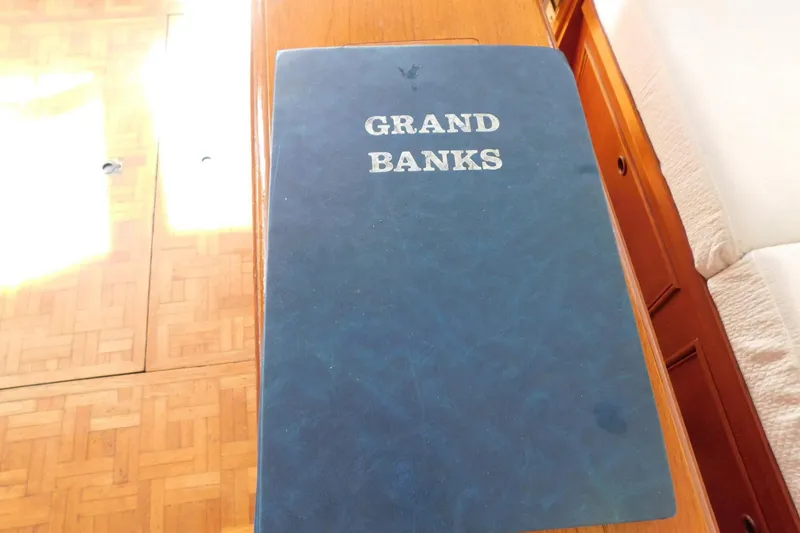 Slide: The Image of Blue Grand Banks manual on wooden table, 1986 Grand Banks 46 Classic yacht interior. - 29