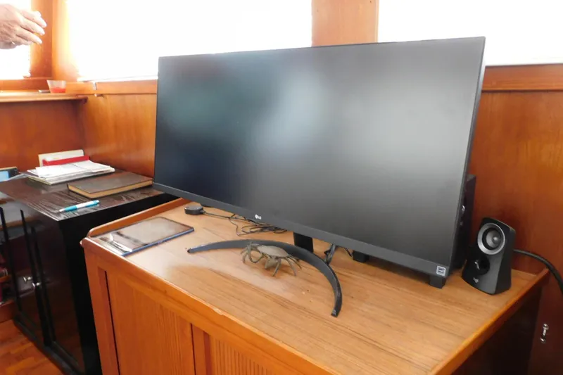 Slide: The Image of Computer monitor on wooden desk inside 1986 Grand Banks 46 Classic yacht interior. - 9