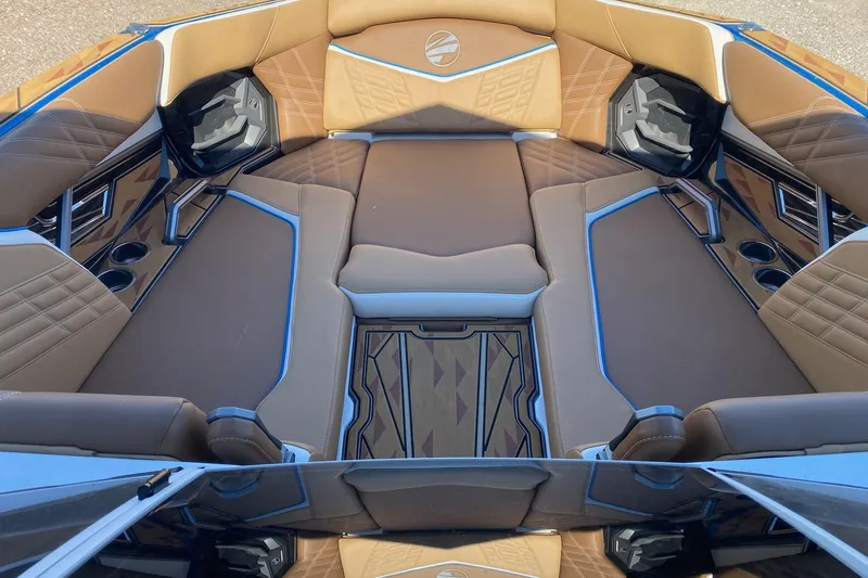 Slide: The Image of 2025 Tigé Ultré 25ZX boat interior with luxurious brown and blue seating. - 11