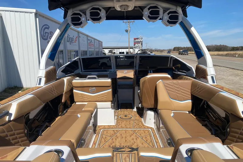 Slide: The Image of 2025 Tigé Ultré 25ZX boat interior with luxurious tan seating and advanced dashboard. - 6