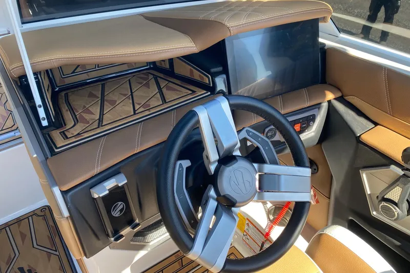 Slide: The Image of 2025 Tigé Ultré 25ZX boat interior with modern steering wheel and dashboard. - 7