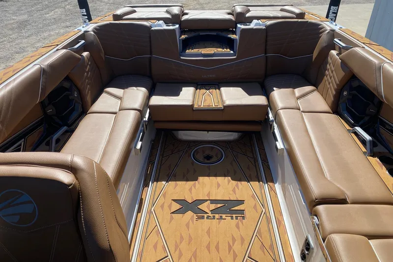Slide: The Image of 2025 Tigé Ultré 25ZX boat interior with luxurious brown leather seating and stylish flooring. - 12