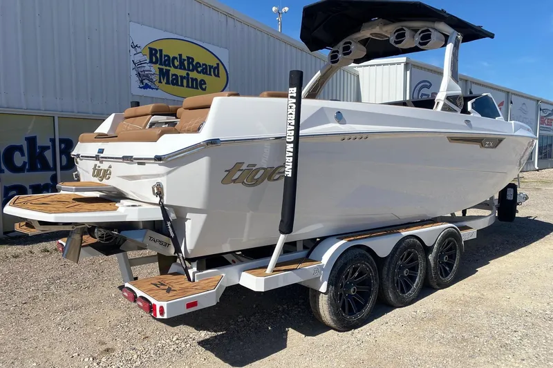 Slide: The Image of 2025 Tigé Ultré 25ZX boat on trailer at BlackBeard Marine dealership. - 6