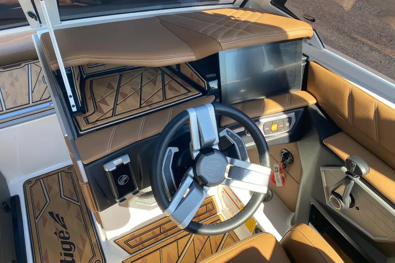 Slide: The Image of 2025 Tigé Ultré 25ZX boat interior with modern steering wheel and touchscreen display. - 7