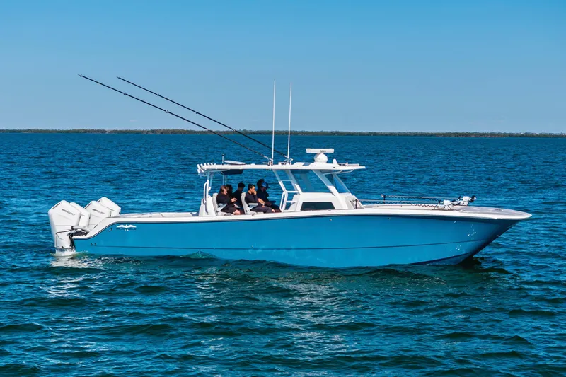 Slide: The Image of 2024 Invincible 46 Catamaran cruising on open water, featuring a sleek blue design. - 0