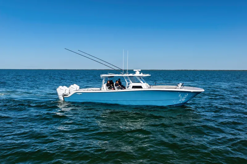 Slide: The Image of 2024 Invincible 46 Catamaran cruising on open water under clear blue skies. - 1