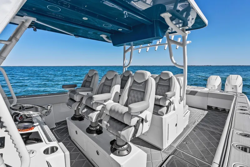 Slide: The Image of 2024 Invincible 46 Catamaran interior with luxury seating on open water. - 12