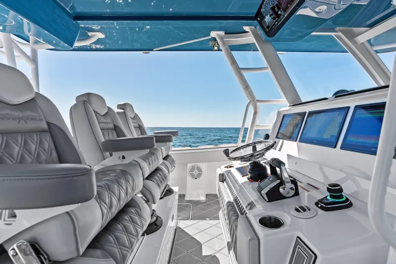 Slide: The Image of 2024 Invincible 46 Catamaran cockpit with luxury seating and advanced navigation systems. - 14