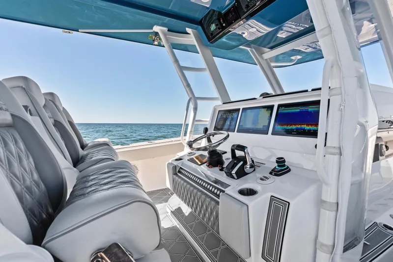 Slide: The Image of Luxurious helm of 2024 Invincible 46 Catamaran with advanced navigation displays and plush seating. - 16