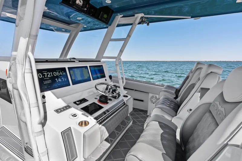 Slide: The Image of 2024 Invincible 46 Catamaran helm with advanced navigation displays and luxurious seating. - 17
