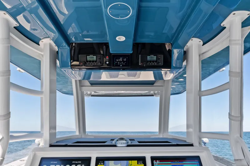 Slide: The Image of 2024 Invincible 46 Catamaran helm with advanced navigation systems and ocean view. - 19