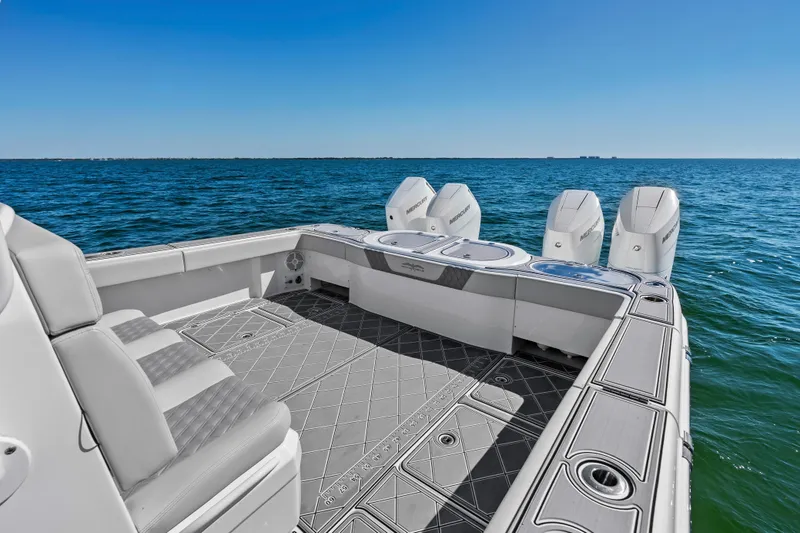 Slide: The Image of 2024 Invincible 46 Catamaran with four engines, spacious deck, and ocean view. - 22