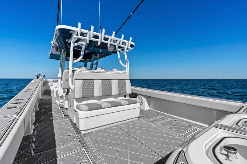 Slide: The Image of 2024 Invincible 46 Catamaran on open sea, showcasing spacious deck and seating. - 23