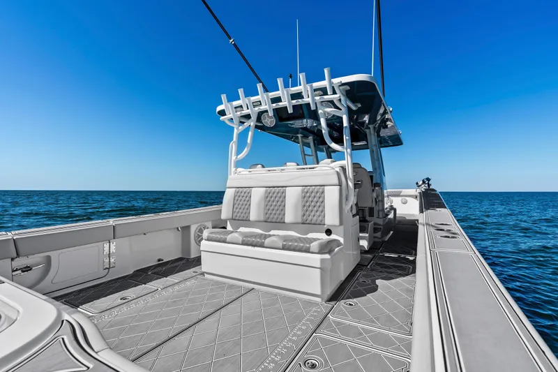 Slide: The Image of 2024 Invincible 46 Catamaran on open sea, showcasing spacious deck and seating. - 25