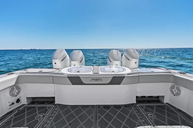 Slide: The Image of 2024 Invincible 46 Catamaran with quad Mercury engines on open sea. - 28