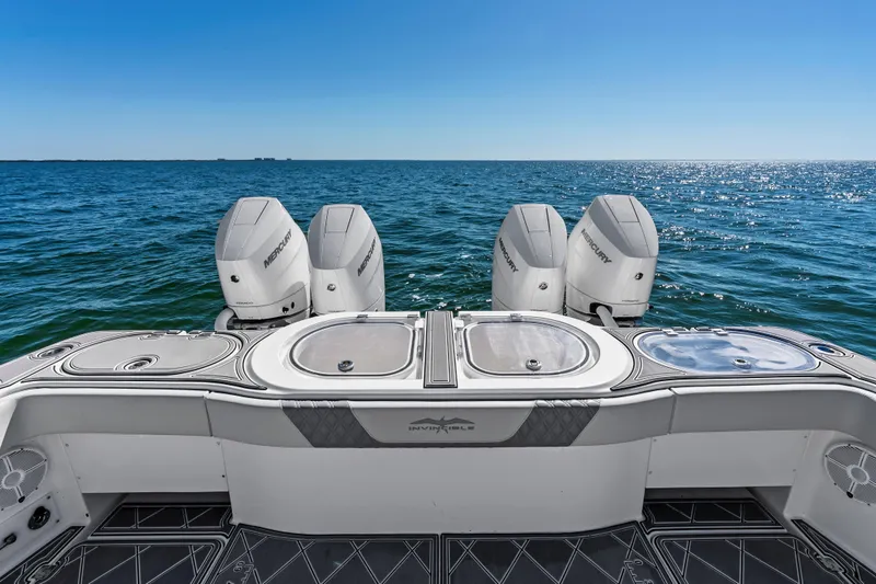 Slide: The Image of 2024 Invincible 46 Catamaran with four Mercury engines on open sea. - 29