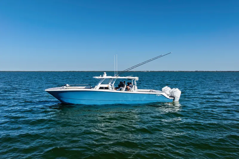 Slide: The Image of 2024 Invincible 46 Catamaran on open water, featuring sleek blue design and powerful engines. - 3