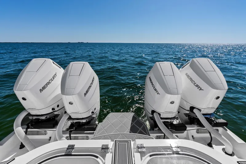 Slide: The Image of 2024 Invincible 46 Catamaran with four Mercury outboard engines on open sea. - 30