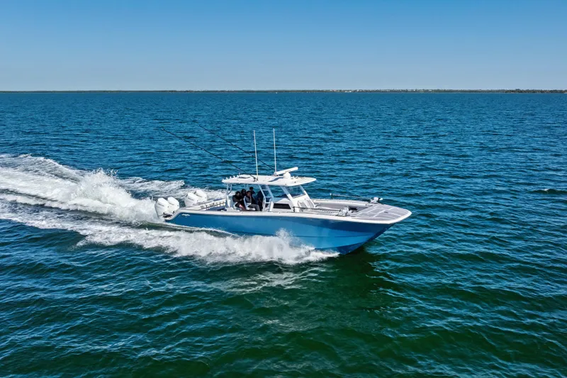 Slide: The Image of 2024 Invincible 46 Catamaran cruising on open water under clear blue sky. - 5