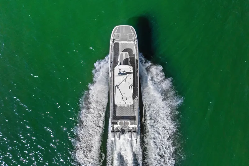 Slide: The Image of Aerial view of 2024 Invincible 46 Catamaran cruising on green water. - 6
