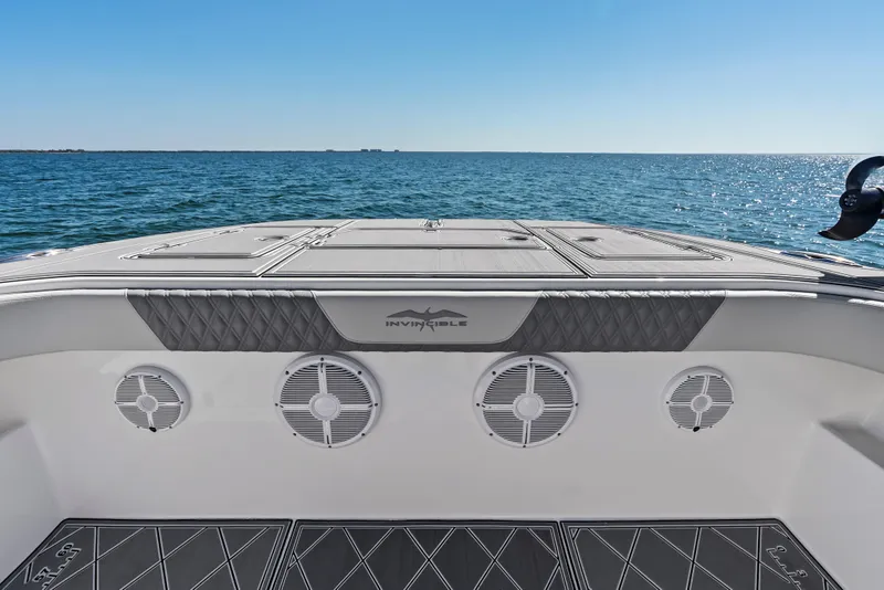 Slide: The Image of 2024 Invincible 46 Catamaran deck view with ocean backdrop. - 9