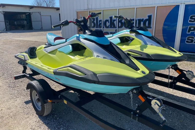 Slide: The Image of 2025 Yamaha WaveRunner JetBlaster on trailer, vibrant yellow and blue design. - 2