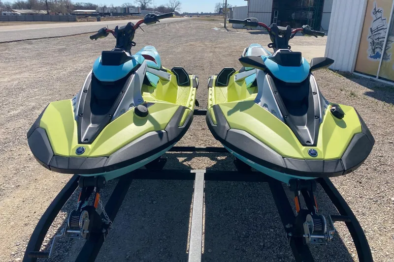 Slide: The Image of 2025 Yamaha WaveRunner JetBlaster, lime green and blue, parked on a trailer outdoors. - 3