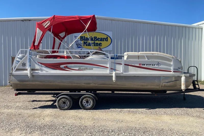 The Image of 2007 JC SunToon 23TT pontoon boat with red canopy on trailer at BlackBeard Marine. - 1