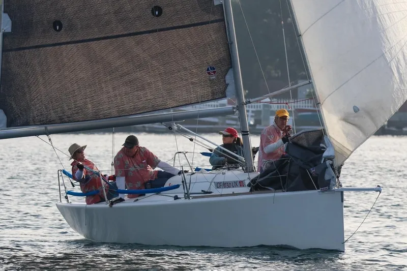 The Image of Sailboat Beneteau 25 Platu 1997 with crew sailing on calm waters. - 1