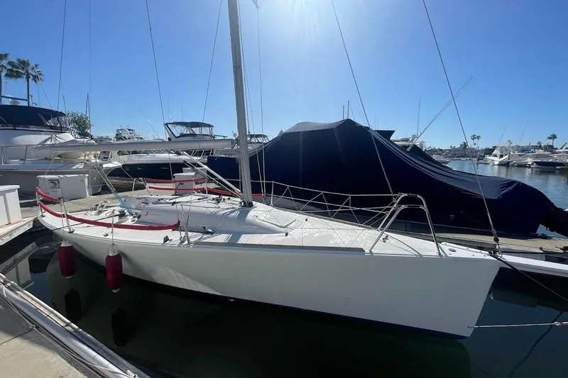 Slide: The Image of 1997 Beneteau 25 Platu sailboat docked in a sunny marina. - 3